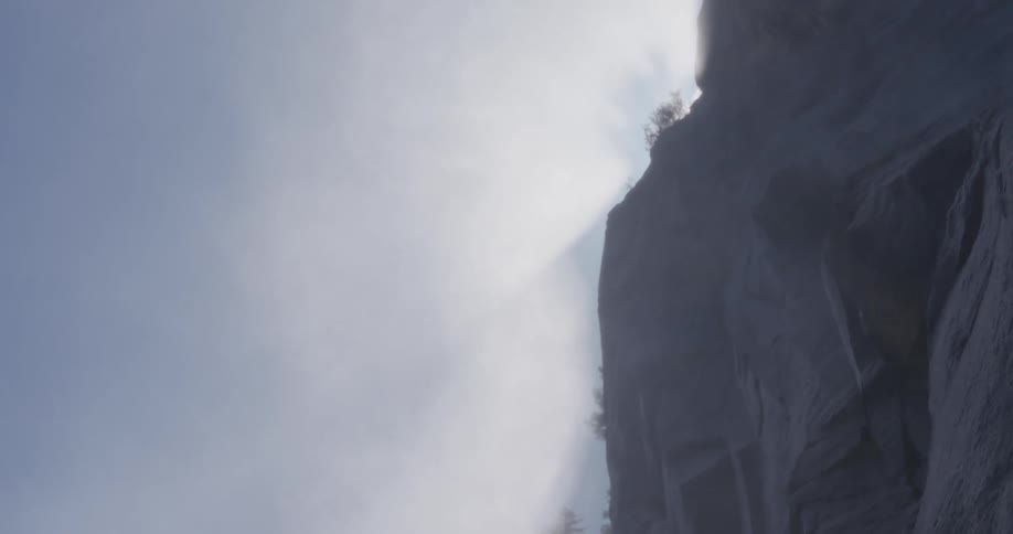 Wall of a mountain with fog in daylight