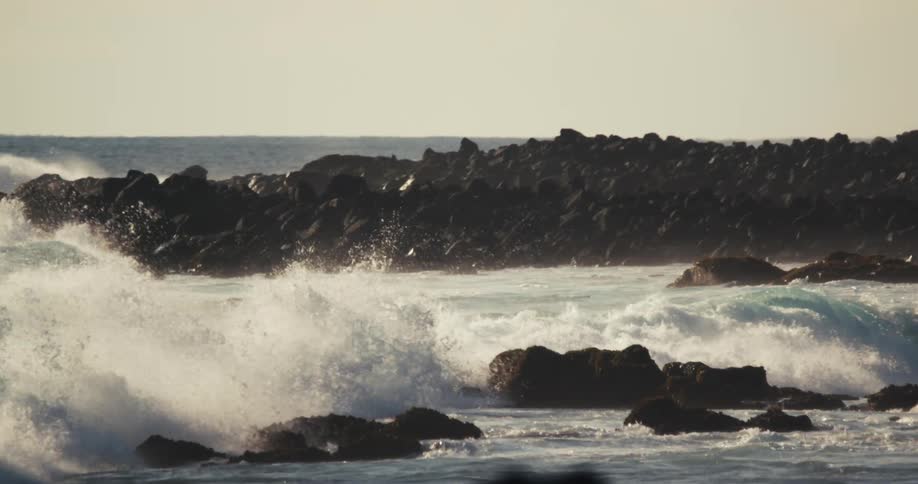 Ocean waves breaking against rocky shore