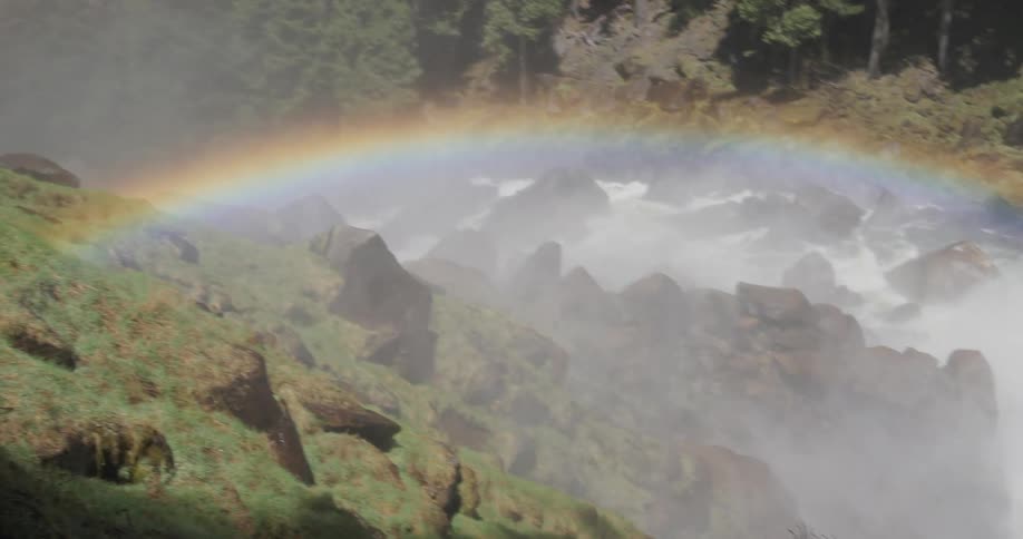 Natural environment with mountains waterfall and a rainbow