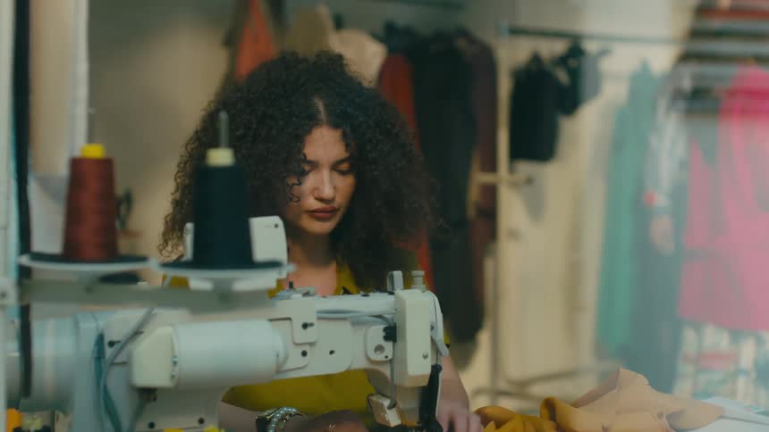 A footage of a female sewing a dress