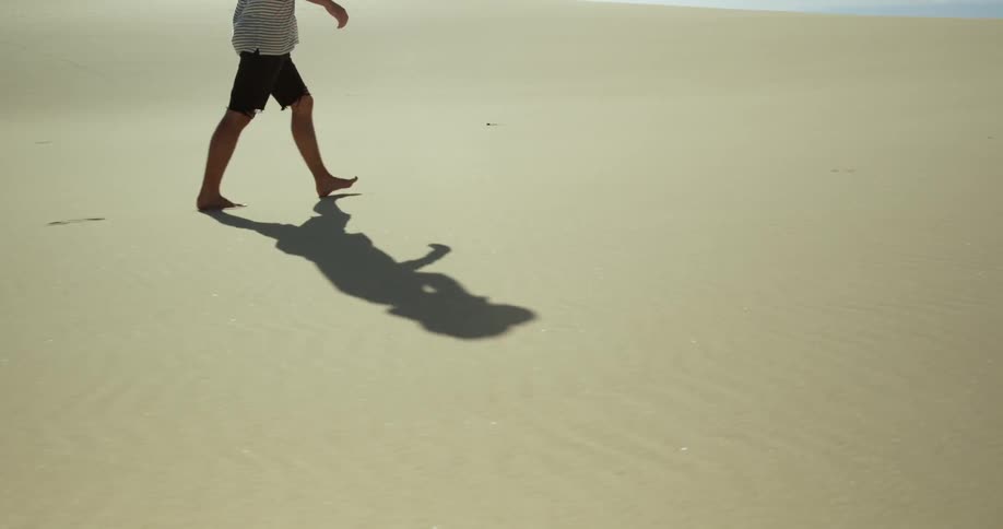 A man walks on the sand
