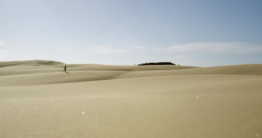Person walking through the desert on a sunny day