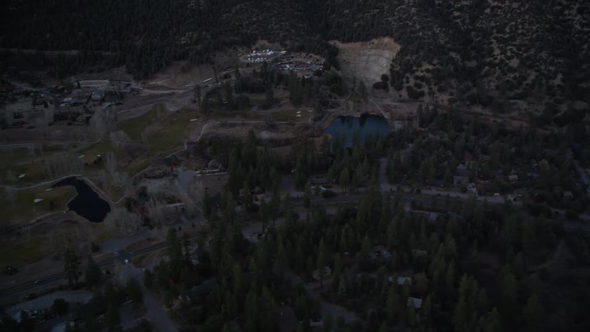 Aerial view of a small town in the hills at dusk