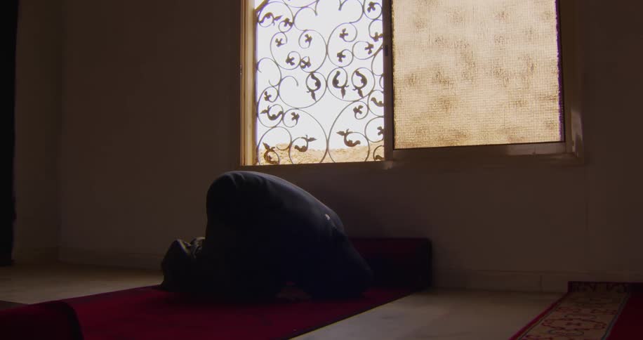 Man kneeling kissing the carpet and standing up