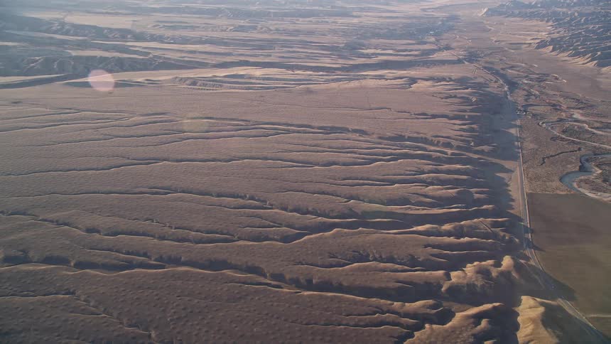Aerial panorama of a geological valley with arid vegetation