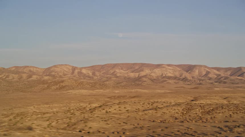 Aerial panorama of a mountainous valley with arid vegetation