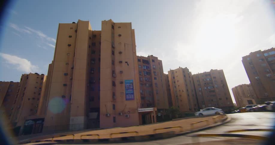 Moving view from inside a car of standardized buildings in a metropolis