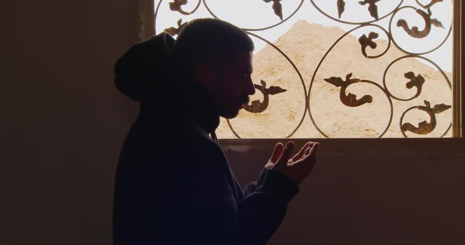 A young man prays in a mosque