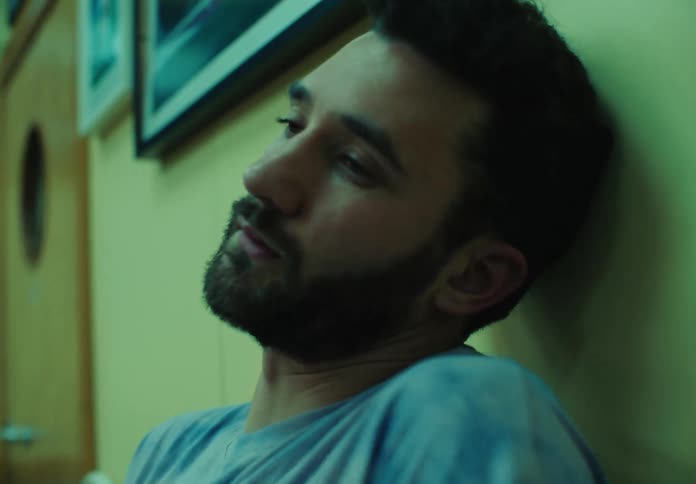 Portrait of a man indoors with face shaking