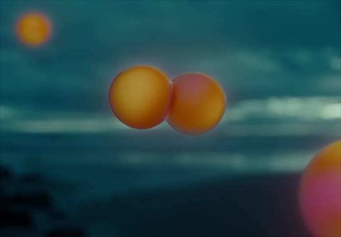 Several orbs changing color from pink to orange and back floating in the air