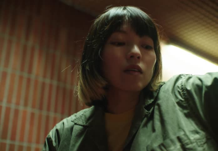A young woman making some gestures with her arms and she is moving