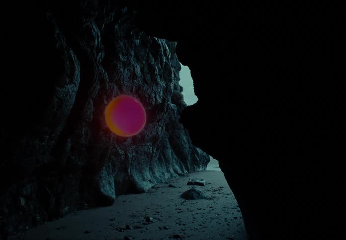 A spinning red and orange ball coming out of a stone cave
