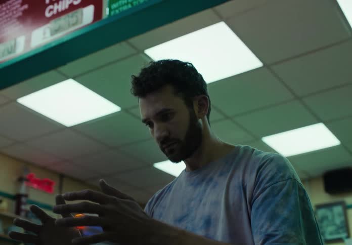 Man indoors handling a glowing abstract sphere that floats