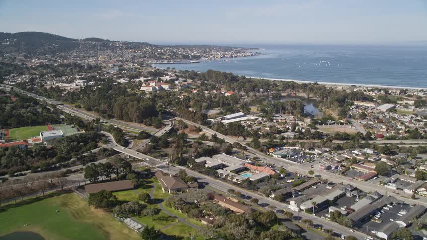 Aerial panorama of an urban city with the stadium golf courses and the edge of a vast ocean