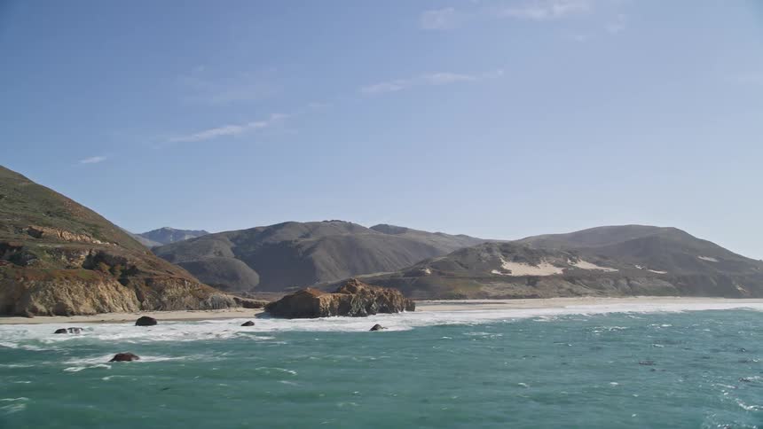 Ocean landscape with algae bathing the mountainous coast