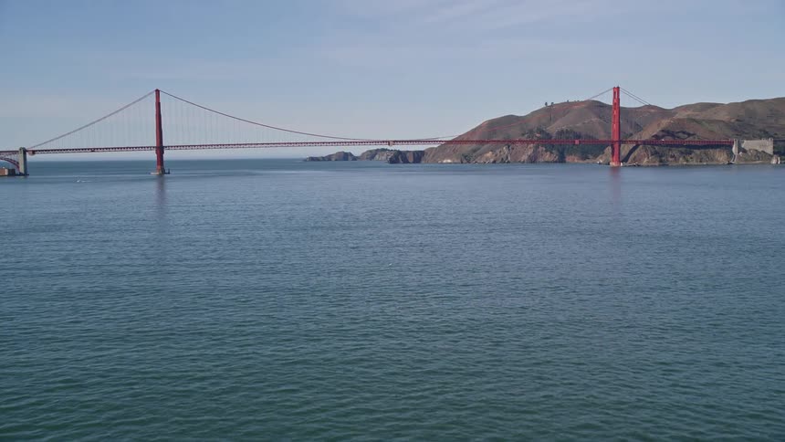 Boat traveling by sea towards golden gate bridge