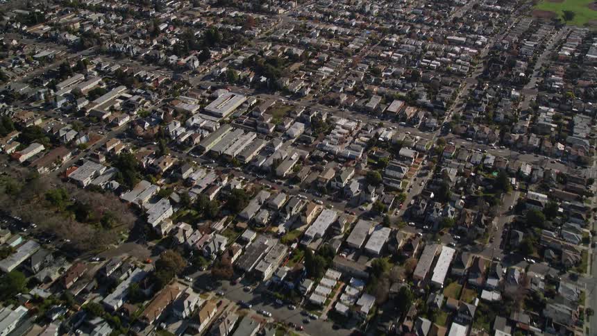Traffic flows along streets passing through residential neighborhood