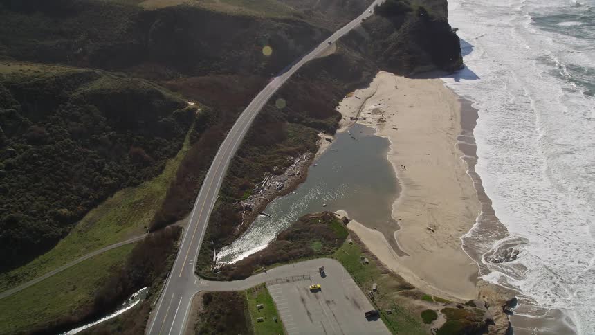 Aerial landscape of a highway stretching along the mountainous seaside coast