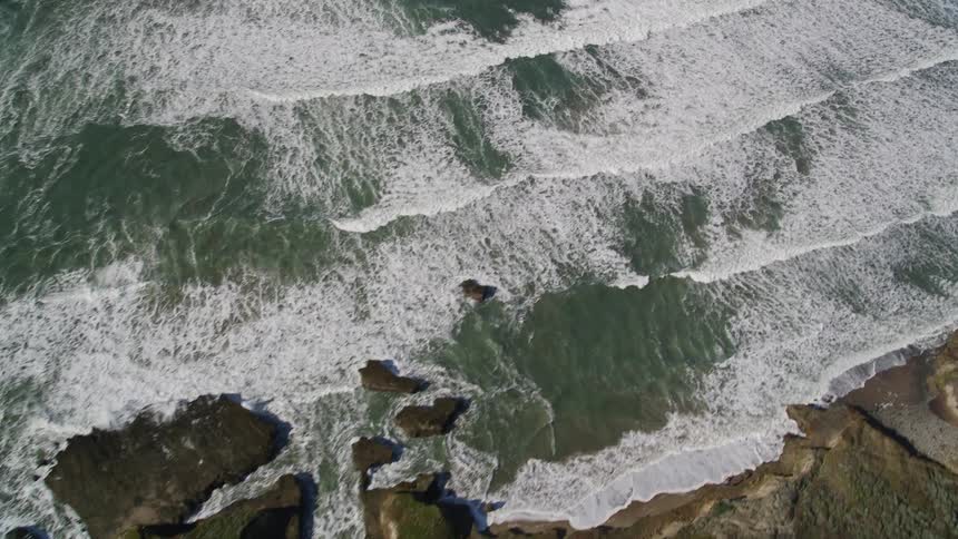 Landscape of an ocean with waves reaching the coast