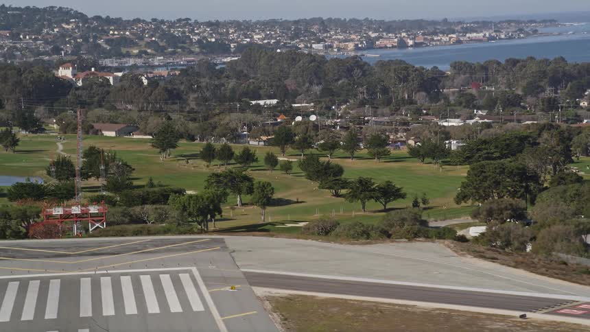 Panorama of an urban city with an airport runway and the seafront