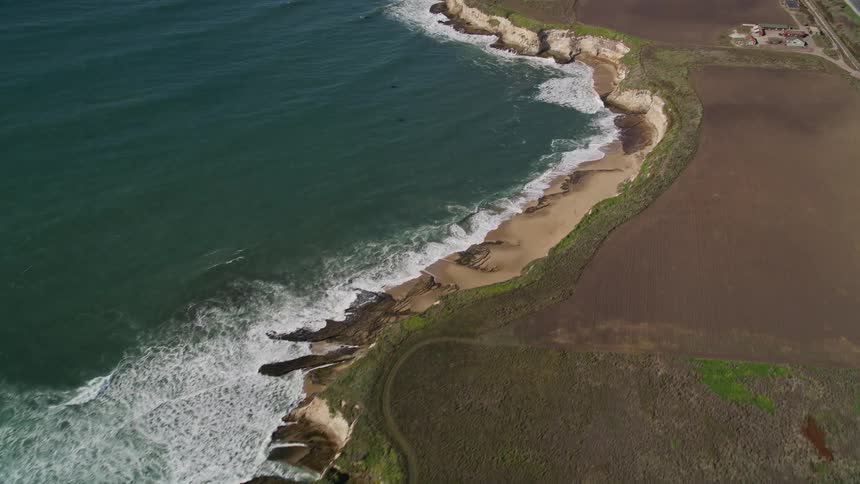 Aerial panorama of the ocean at the coast with an extensive highway