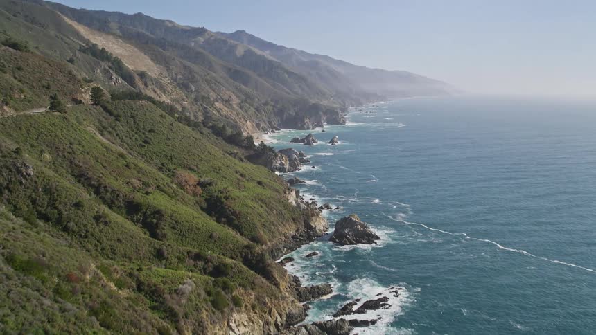 Aerial panorama of a peninsula with a rocky and mountainous crust on the edge of a vast blue sea