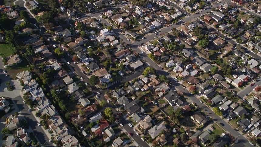 Aerial view of a large residential neighborhood with intersections seen during the day