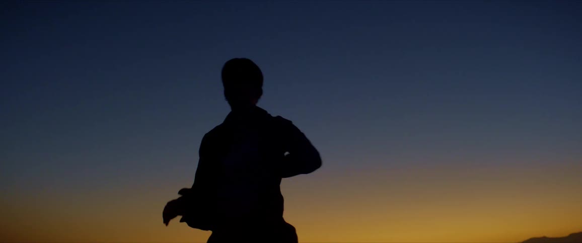Male dancer silhouetted against the afterglow dances
