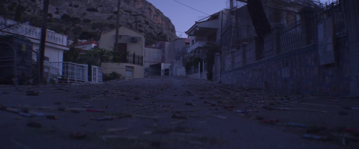 Litter covers the ground in a run down neighborhood
