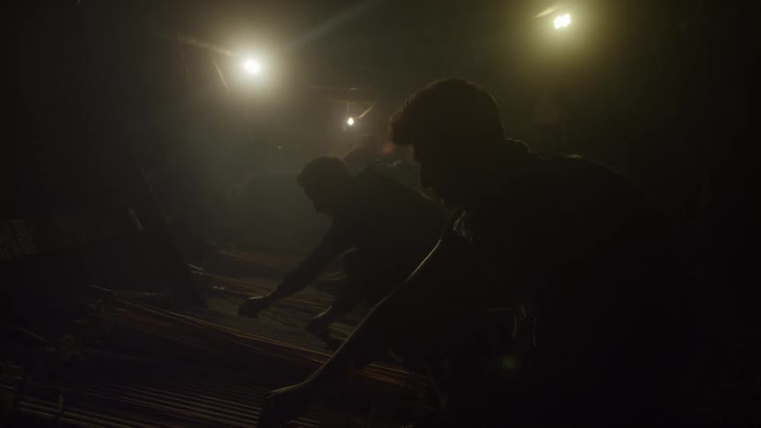 Men sorting arrows in the dark