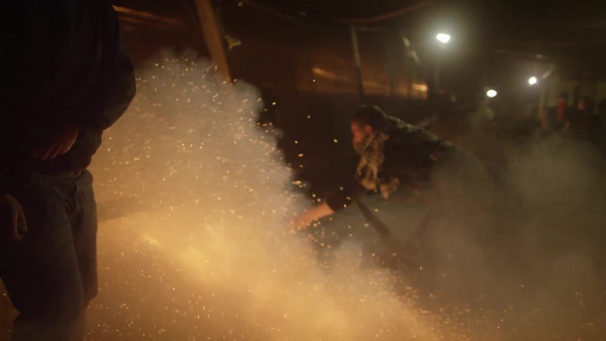 Sparks are flying as fireworks fly all over a night sky