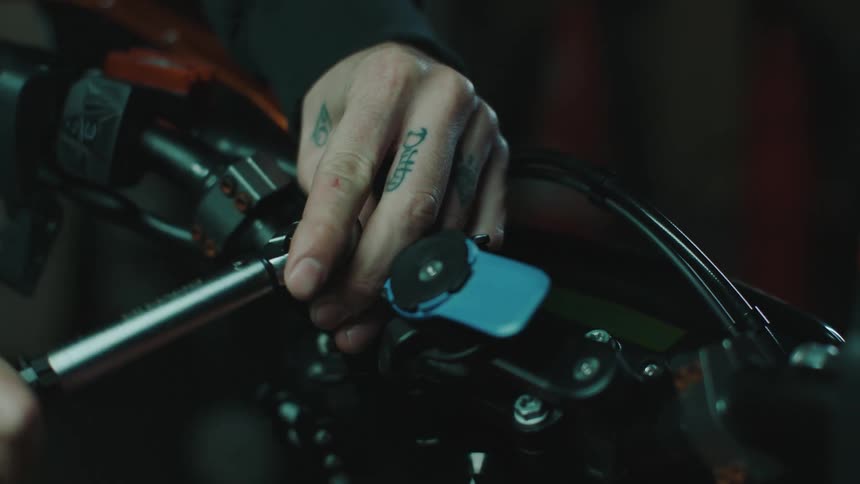 A mechanic is fixing a motorcycle