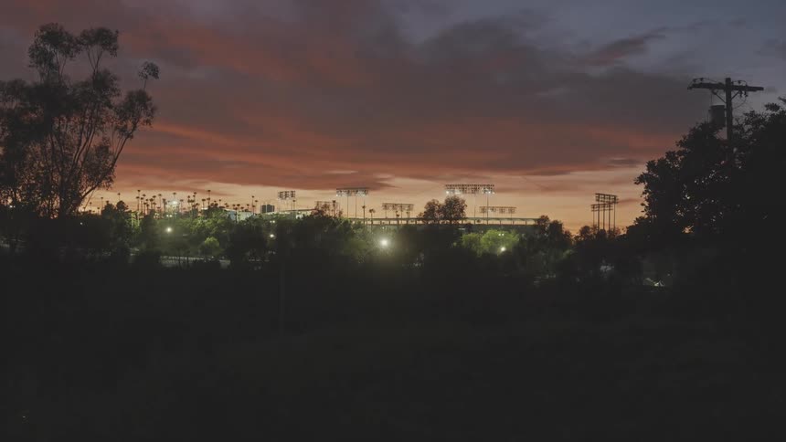 The sun is setting on the stadium