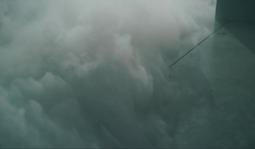 A dense white smoke on a concrete textured floor