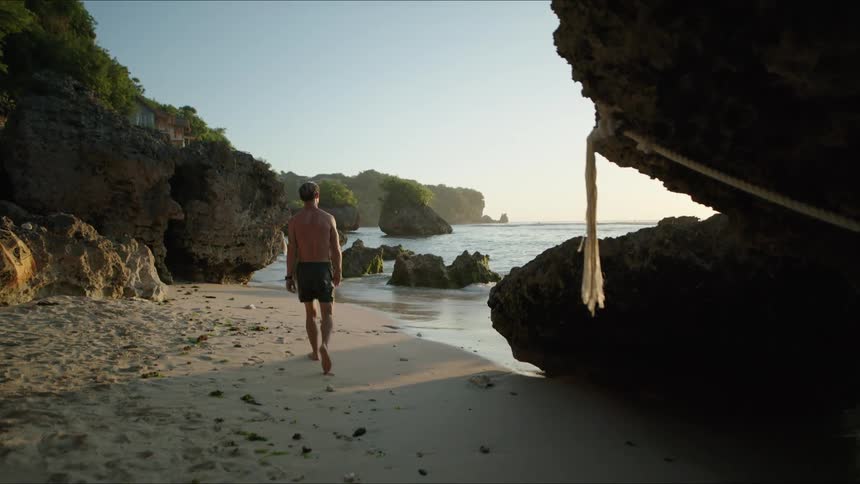 A man walks along the beach