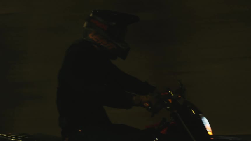 A person in a helmet is driving a motorcycle at high speed