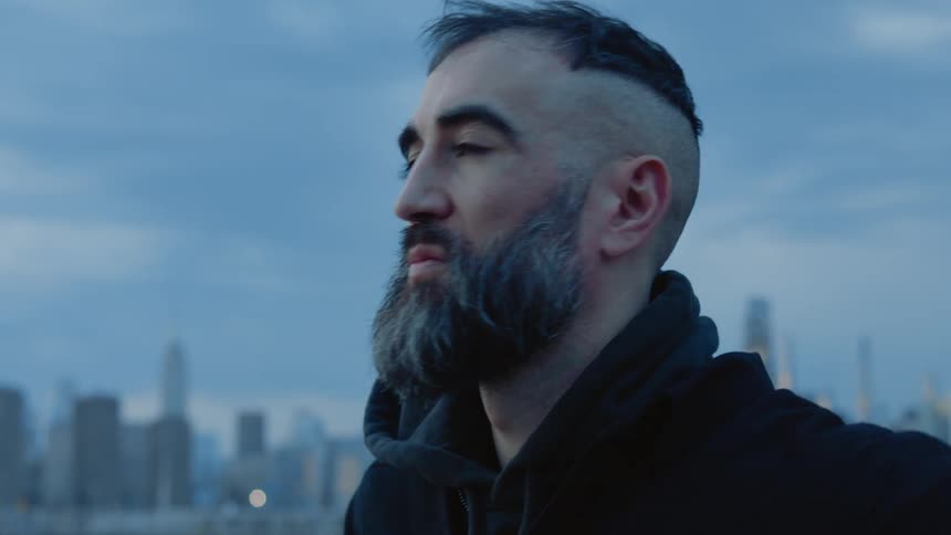 A man is standing before the city