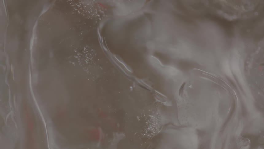 The ice filled liquid turns in a circle
