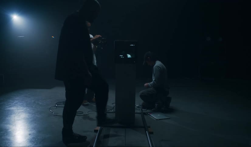 Men are working in the dark studio