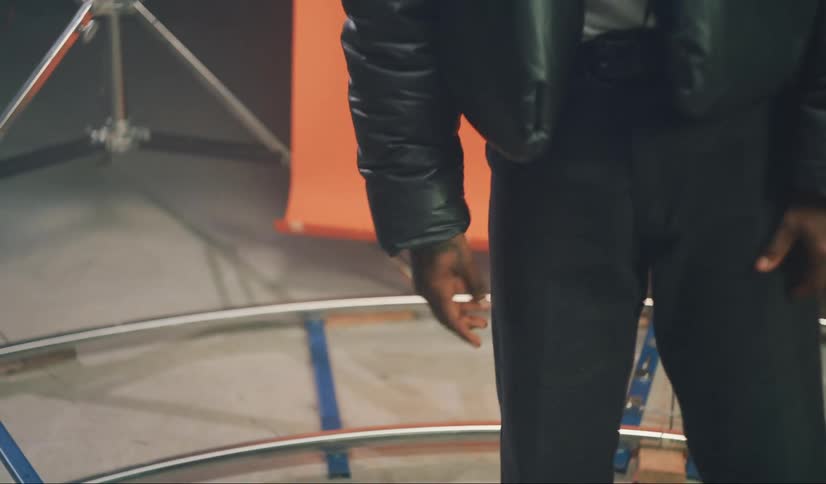 A man is modeling clothes in the studio