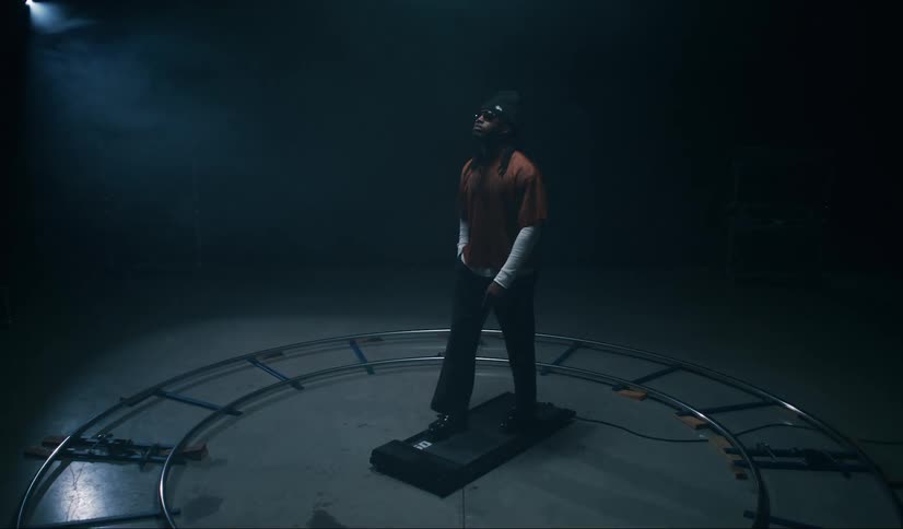 A man is walking on a treadmill on stage