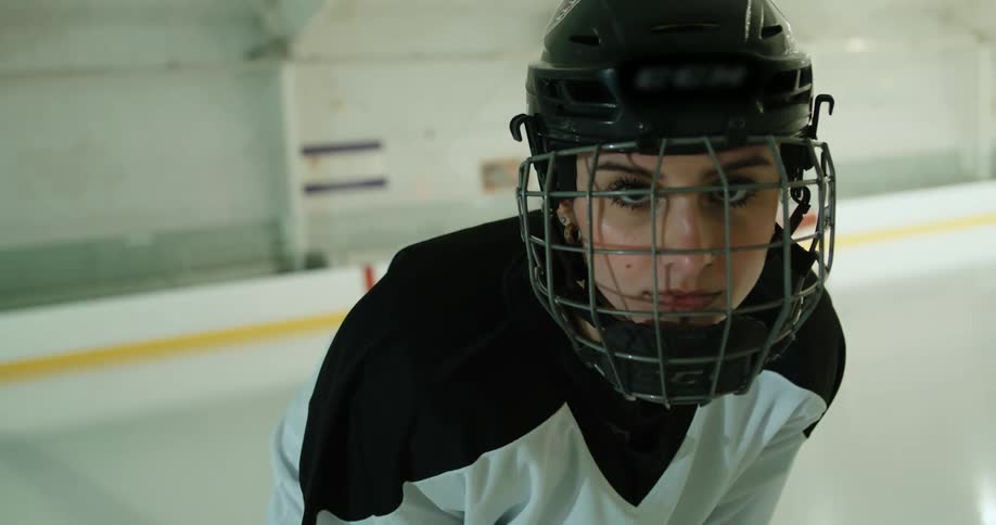 A hockey player is ready on the ice