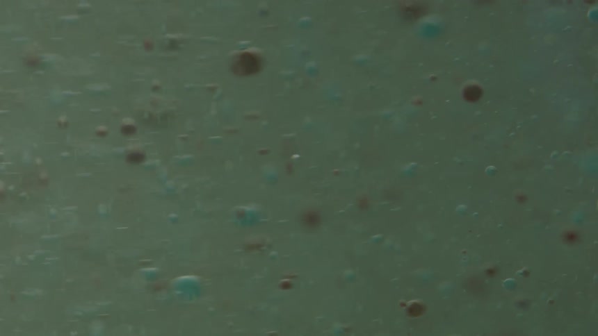 Bubbles float downward in thick liquid