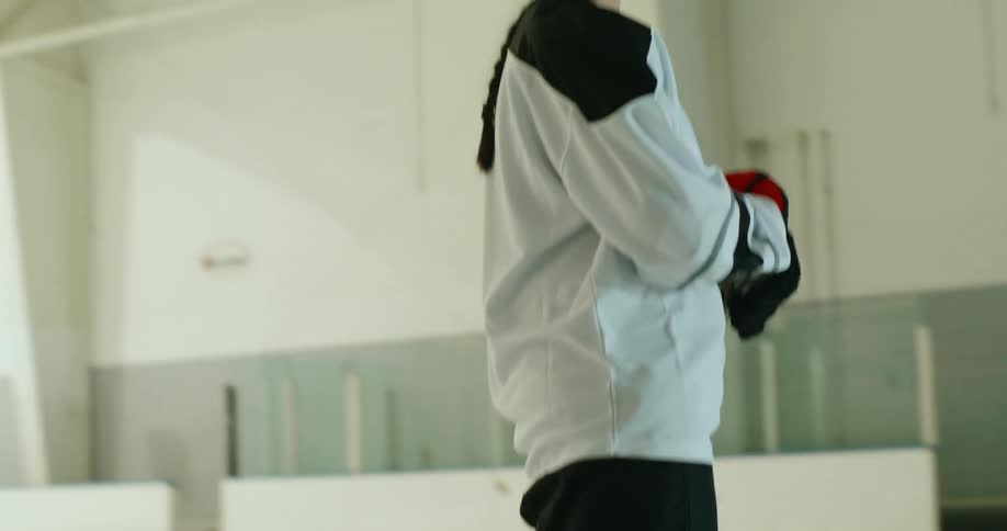 A hockey player prepares to hit the puck
