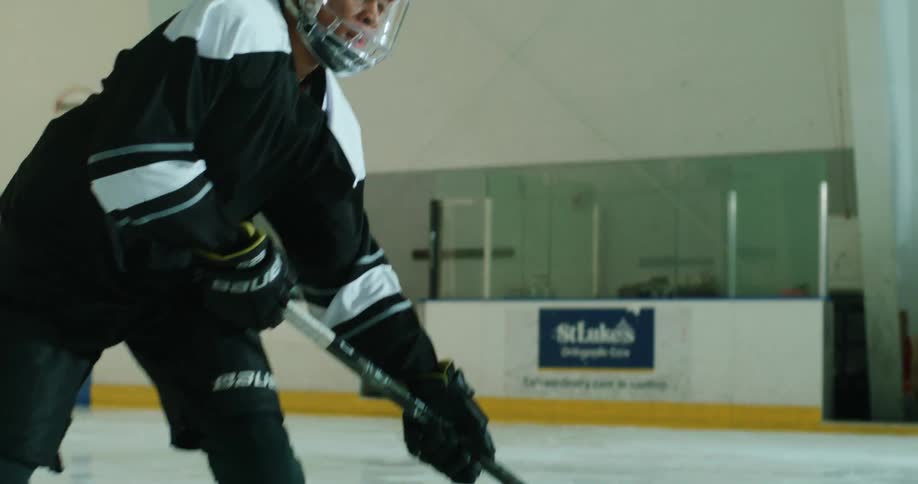 A hockey player shoots and scores on the rink