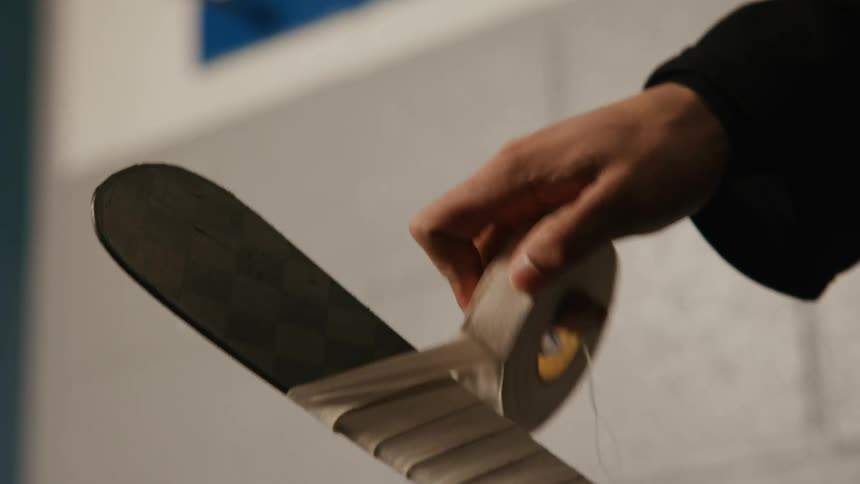 Tape being placed on a hockey equipment