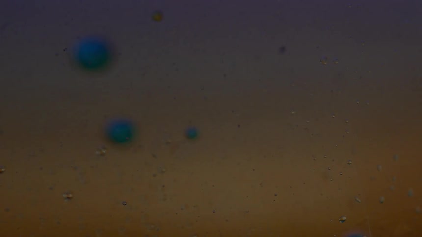 Liquid bubble floating through color changing lit up liquid