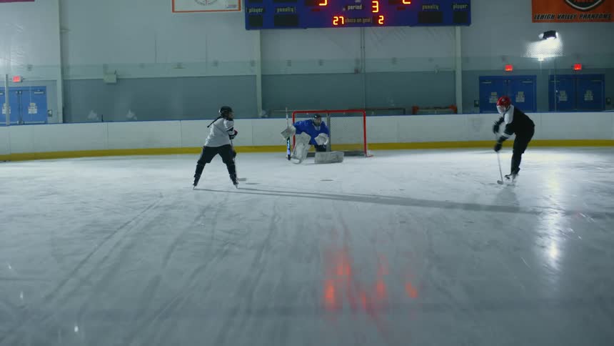 A goalie blocks the puck in the game
