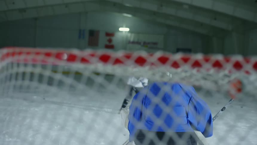 Three people training on a hockey court