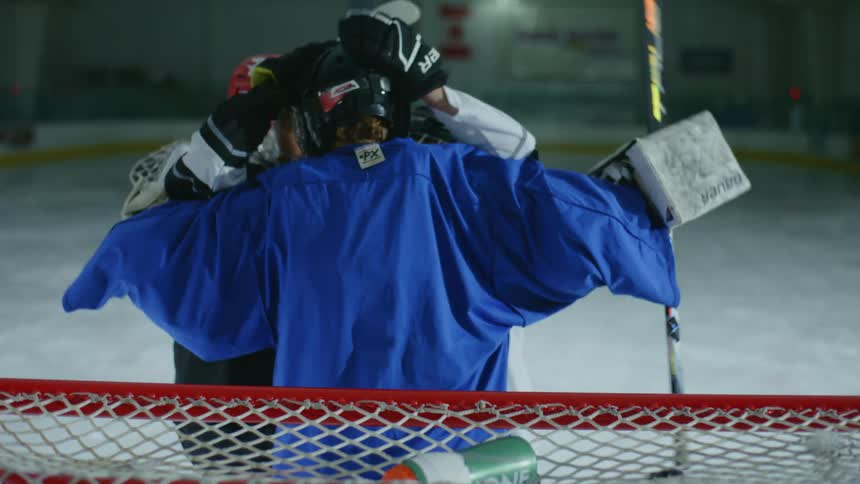 Hockey players celebrate with high fives and hugs